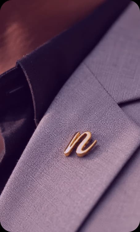 Gold n lapel pin on a lilac suit jacket